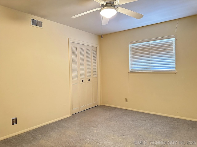 unfurnished bedroom featuring light carpet, ceiling fan, and a closet