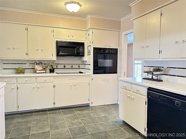 kitchen featuring white cabinetry, crown molding, decorative backsplash, and black appliances