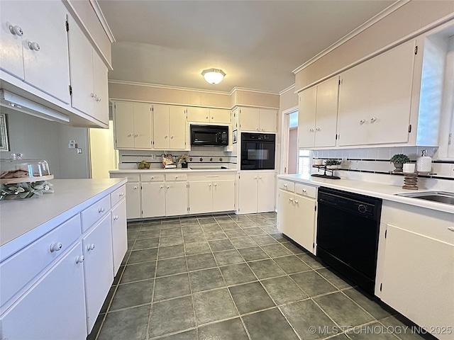 kitchen featuring decorative backsplash, sink, white cabinets, and black appliances