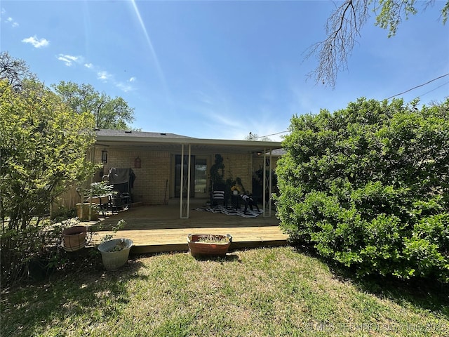 814 Pershing E, Ardmore, OK 73401 - back of property with a wooden deck, a yard, and brick siding