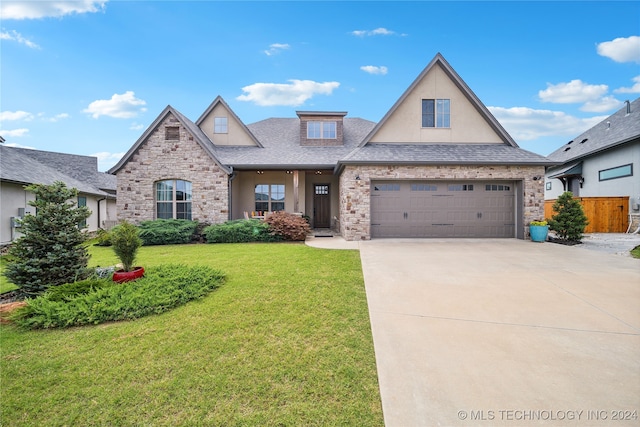 view of front of property featuring a front lawn and a garage