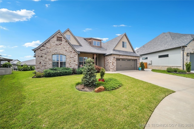 view of front of home featuring a garage and a front yard