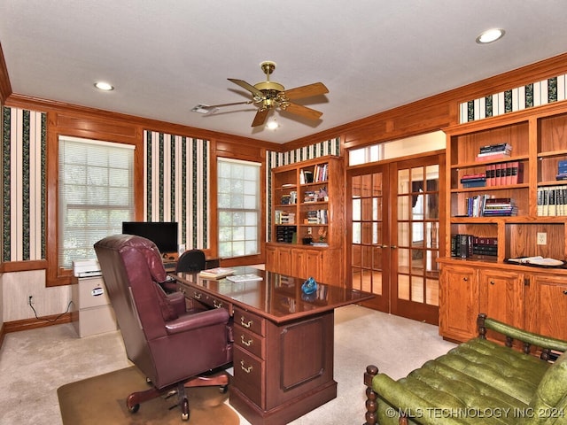 carpeted office space featuring ceiling fan, ornamental molding, and built in features