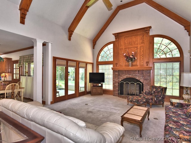 13706 S 18th St, Bixby, OK 74008 - living room featuring ornate columns, high vaulted ceiling, a fireplace, beamed ceiling, and light carpet