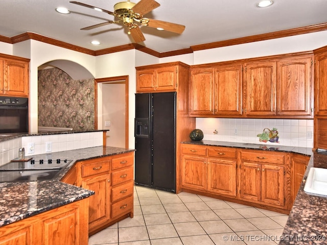 kitchen with black appliances, light tile patterned floors, dark stone countertops, ceiling fan, and decorative backsplash