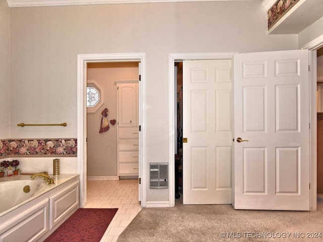 bathroom with tile patterned floors and a bathing tub