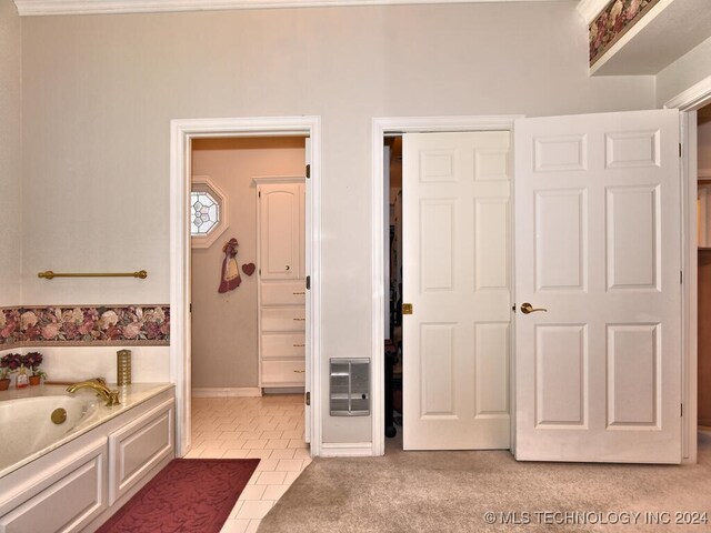 13706 S 18th St, Bixby, OK 74008 - bathroom with heating unit, a bathtub, and tile patterned floors