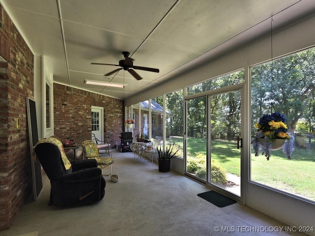 sunroom featuring ceiling fan