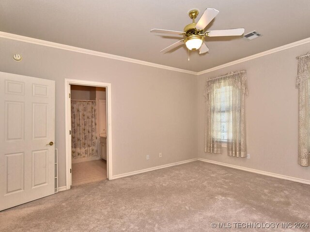 unfurnished bedroom featuring ensuite bath, crown molding, ceiling fan, and carpet floors