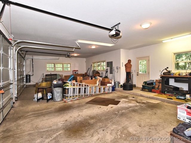 garage featuring electric panel and a garage door opener