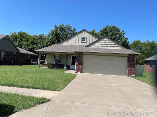 view of front of home featuring a garage and a front lawn