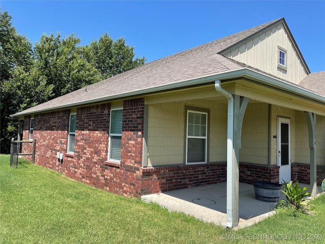 view of side of home with a yard