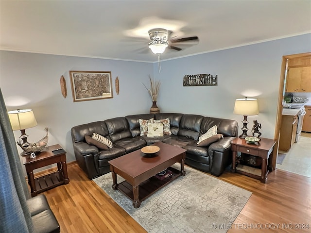 living room with ornamental molding, ceiling fan, and light hardwood / wood-style floors