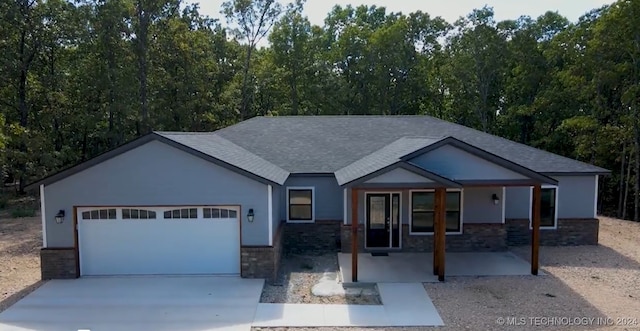 craftsman inspired home featuring a garage and a porch