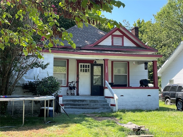 view of front of property with a front yard and covered porch