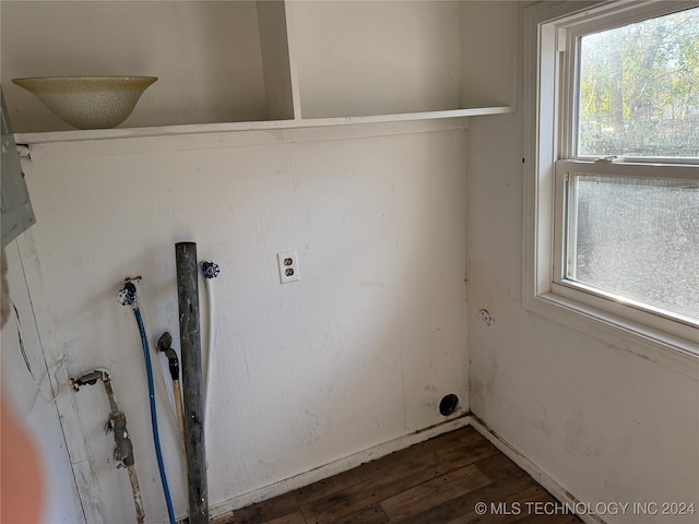 clothes washing area with a wealth of natural light and dark hardwood / wood-style floors