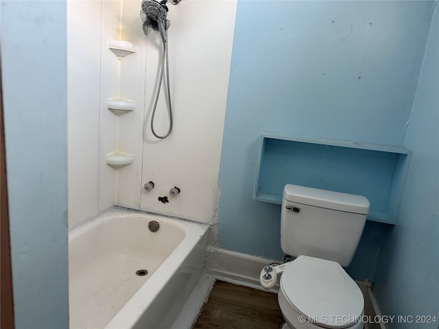 bathroom featuring hardwood / wood-style floors, toilet, and a bathtub