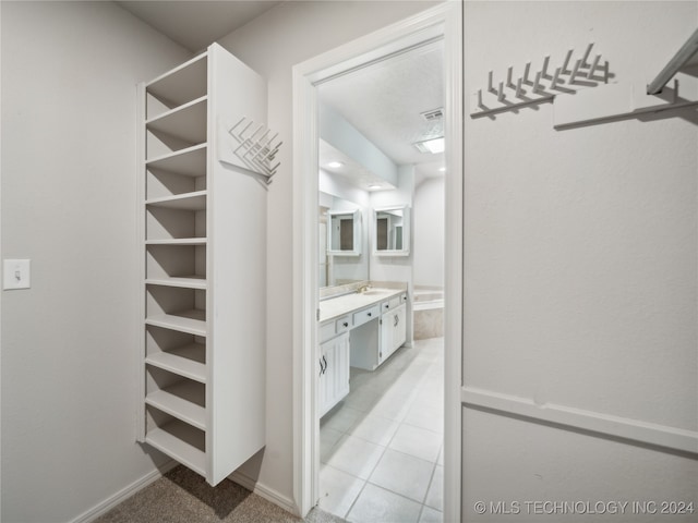 walk in closet featuring light tile patterned floors