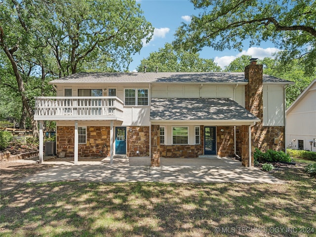 back of house featuring a lawn and central AC unit