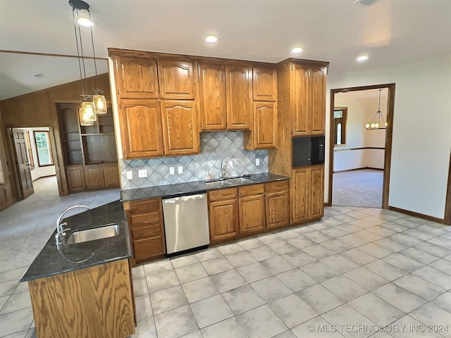 kitchen featuring sink, lofted ceiling, stainless steel dishwasher, and decorative light fixtures