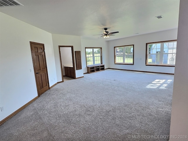 interior space featuring ceiling fan and carpet