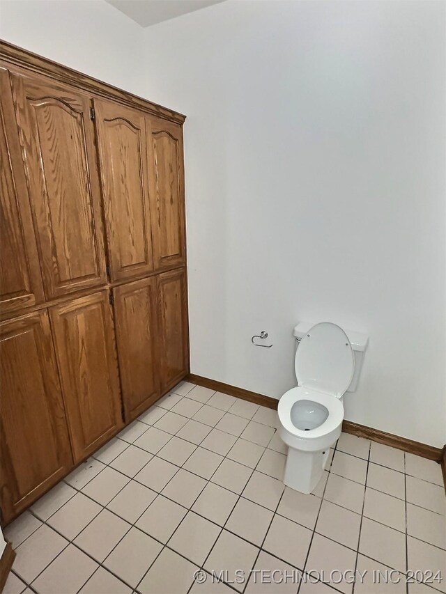 bathroom featuring tile patterned flooring and toilet