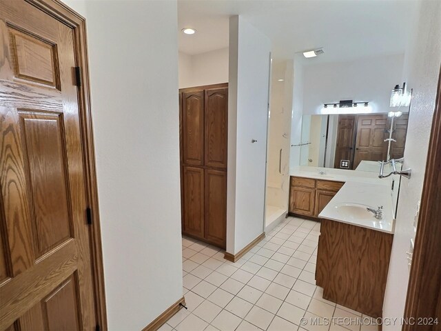 bathroom featuring vanity, tile patterned flooring, and an enclosed shower