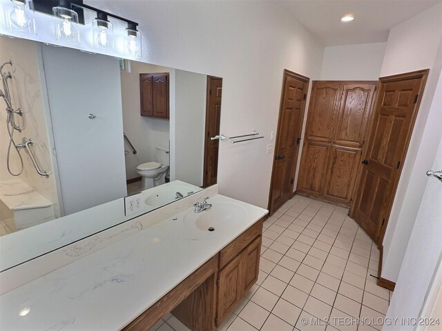 bathroom featuring tile patterned floors, vanity, and toilet