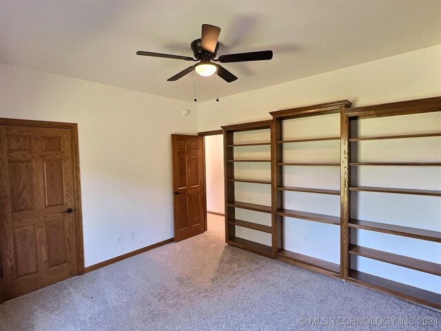 unfurnished bedroom featuring ceiling fan and carpet floors