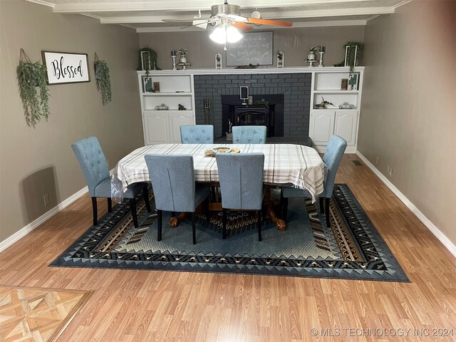 dining room with beam ceiling, wood-type flooring, and ceiling fan