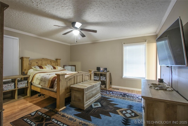 bedroom with ornamental molding, dark wood-type flooring, a textured ceiling, and ceiling fan