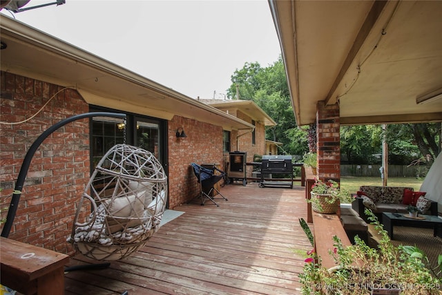 wooden deck featuring grilling area and an outdoor living space