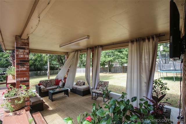 view of patio / terrace with a trampoline and an outdoor living space