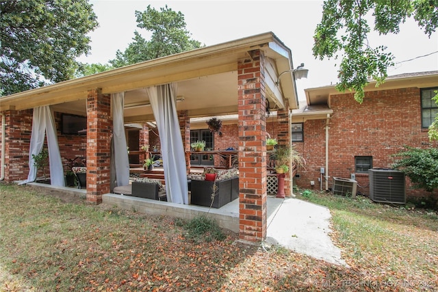 rear view of house featuring central AC and an outdoor hangout area