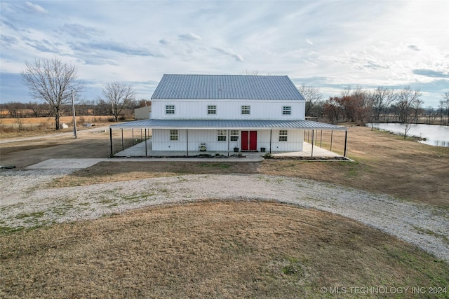 view of front of home with a front yard and covered porch