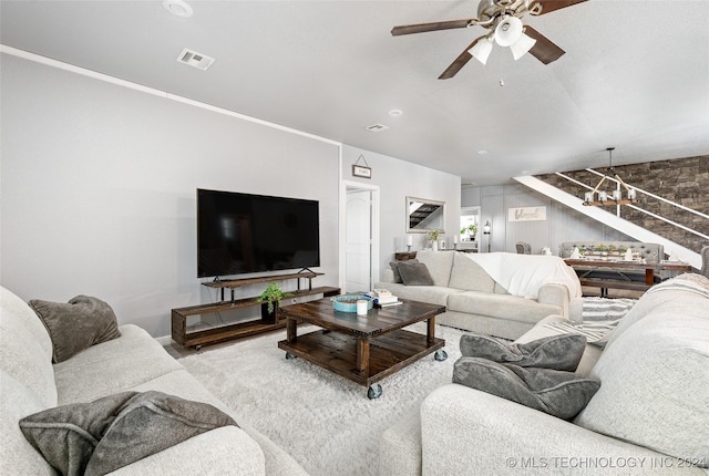 living room with ceiling fan with notable chandelier and wood-type flooring