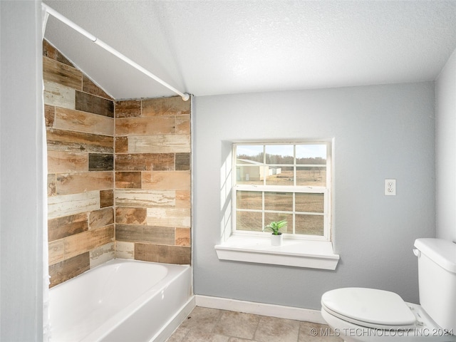 bathroom featuring toilet, washtub / shower combination, wooden walls, and a textured ceiling