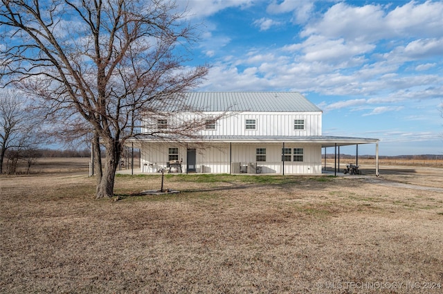 back of property with a lawn