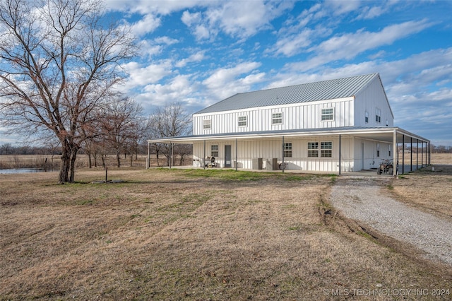 back of property featuring covered porch and a lawn