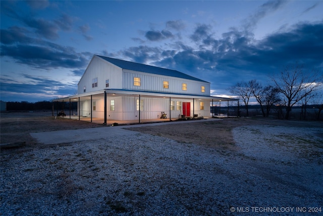 back house at dusk with a carport