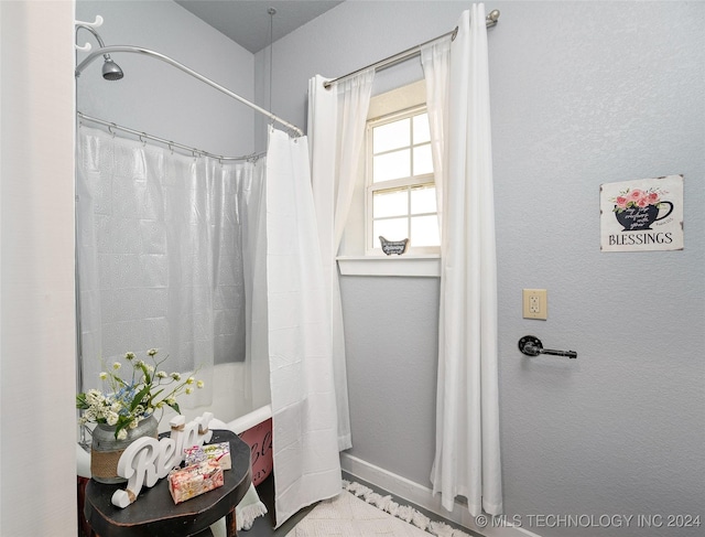 bathroom with shower / bathtub combination with curtain