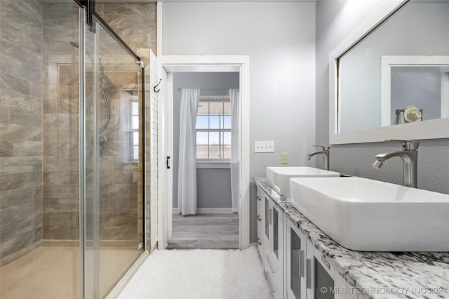 bathroom featuring vanity and an enclosed shower