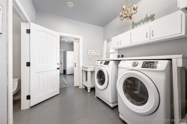 laundry room with cabinets, independent washer and dryer, and a notable chandelier