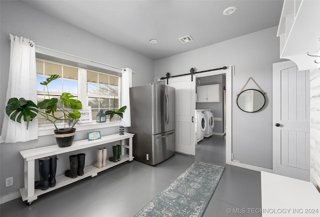 interior space featuring separate washer and dryer and concrete floors