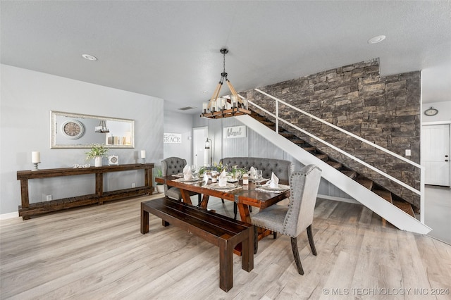 dining area with a chandelier and light hardwood / wood-style flooring