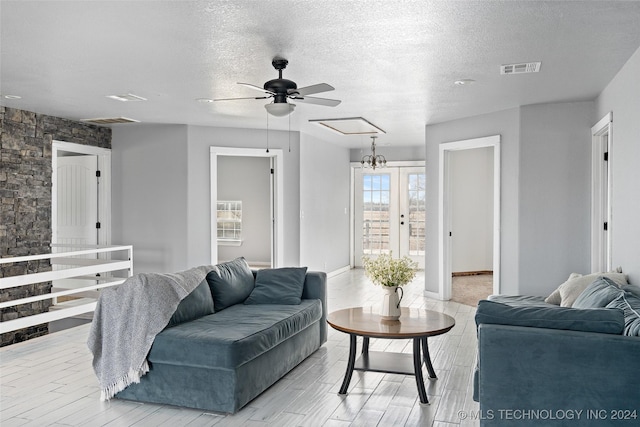 living room with ceiling fan, light hardwood / wood-style floors, french doors, and a textured ceiling