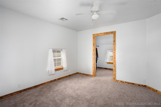 empty room with light colored carpet and ceiling fan