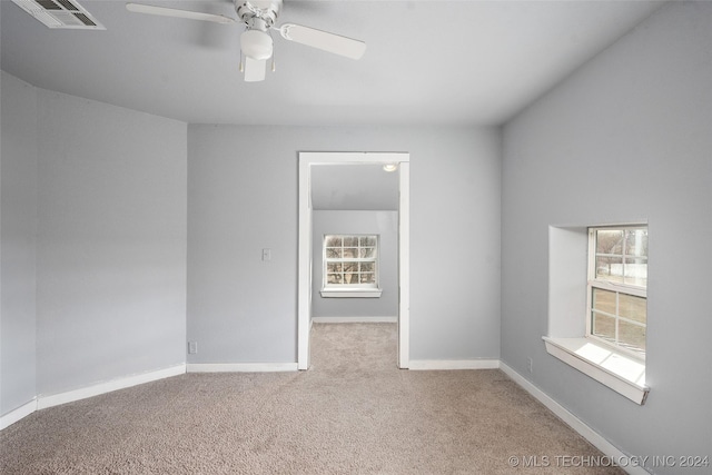 empty room featuring ceiling fan and carpet floors