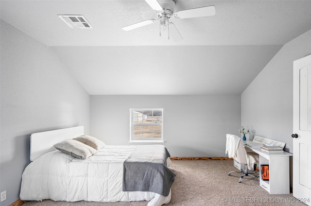 bedroom featuring lofted ceiling, carpet flooring, a textured ceiling, and ceiling fan