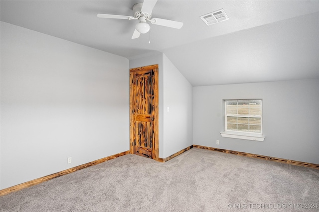 additional living space with lofted ceiling, light colored carpet, and ceiling fan